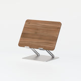 Adjustable laptop stand with walnut finish and coated steel base on white background.