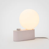 Alumina Lamp in Blossom finish, modern aluminum LED desk light on grey background.