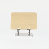 Front view of adjustable laptop stand in light oak finish with steel base on white background.