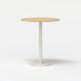 Round light wood tabletop bistro table with white pedestal base on a white background