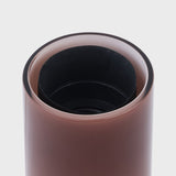 Close-up of Shore table lamp socket and mouth-blown recycled glass base, showing interior build and finish against a light grey background.