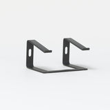 Slim black laptop stand with minimalist metal design on white background