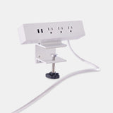 Angled side view of Urbanica clamp-on desk power outlet featuring heavy-duty mounting clamp and extended power cord for desktop charging