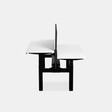 Urbanica two-person standing office desk panel in white laminate with center divider and black adjustable base – side view