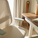 Close-up of the Urbanica Ergonomic Novo Chair, highlighting its breathable mesh back, contoured seat, and soft-touch adjustable armrests in a modern workspace.
