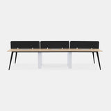 Front view of Urbanica Six Person Office Workstation Desk Panel in light oak finish with black privacy dividers, white center supports, and black angled legs for modern collaborative spaces