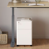 Urbanica white mobile office cabinet with lockable drawers placed under a modern adjustable desk in a minimalist home office setting