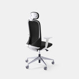 Urbanica Ergonomic Muse Chair Headrest in black, shown from the back with a curved mesh design, white frame, and smooth gliding wheels for office mobility.