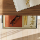 Overhead view of the Urbanica Mini Standing Ergonomic Office Desk drawer featuring organized storage with gold pens, clips, and a notebook